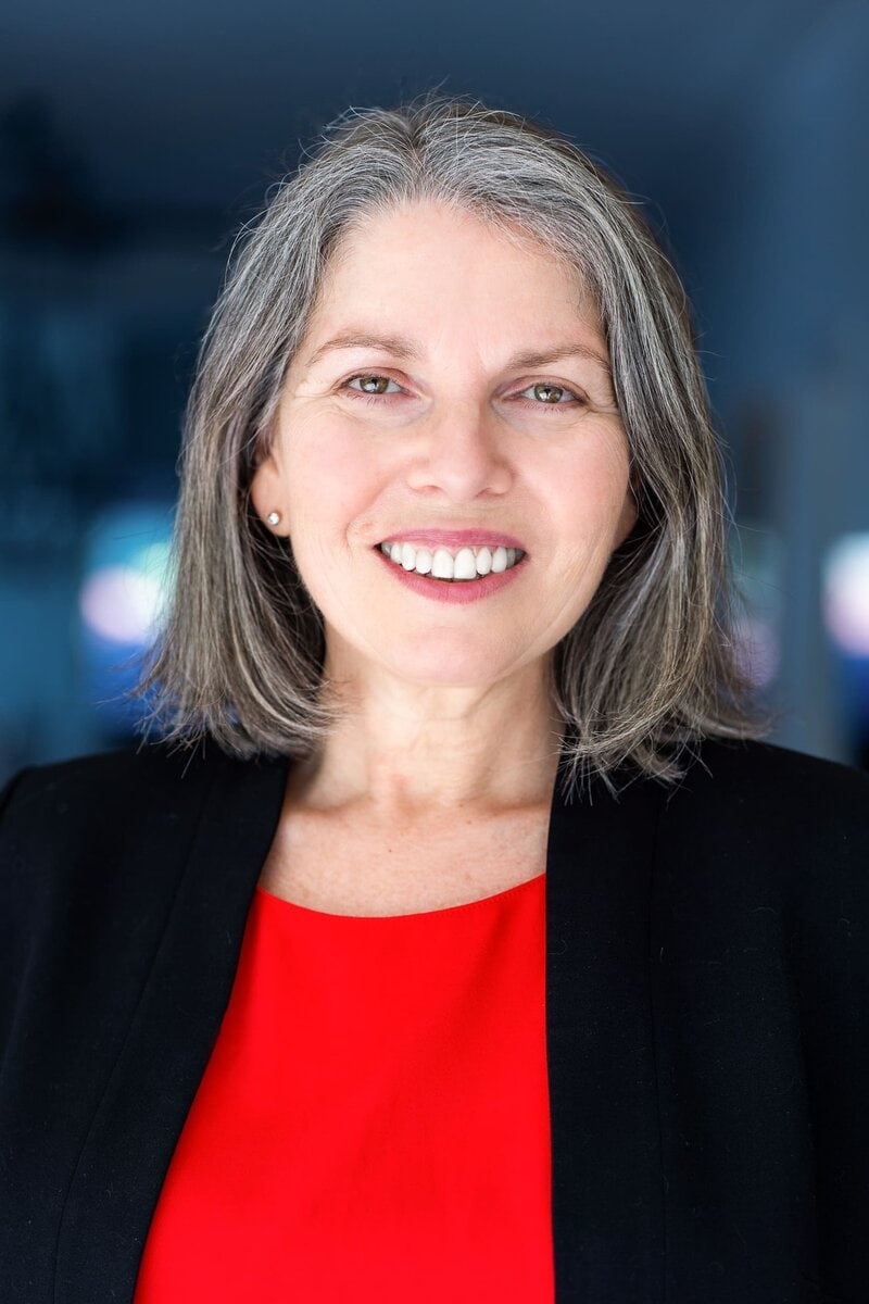 Ext: Leadership coach/author wearing a red top having her headshot taken by professional photographer Georgie Greene in Sydney NSW