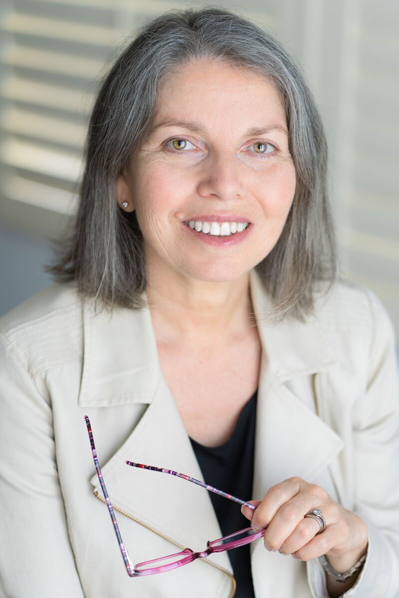 Int: Leadership coach/author wearing a cream jacket having her personal branding headshot taken by Georgie Greene in Sydney NSW