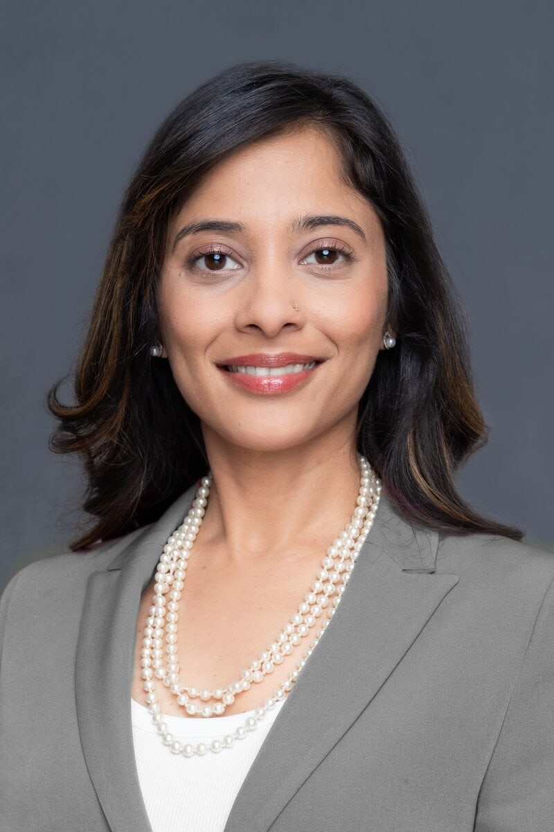 Int: Young Indian woman in grey jacket having Business head shot taken by headshot photographer Georgie Greene in Sydney NSW