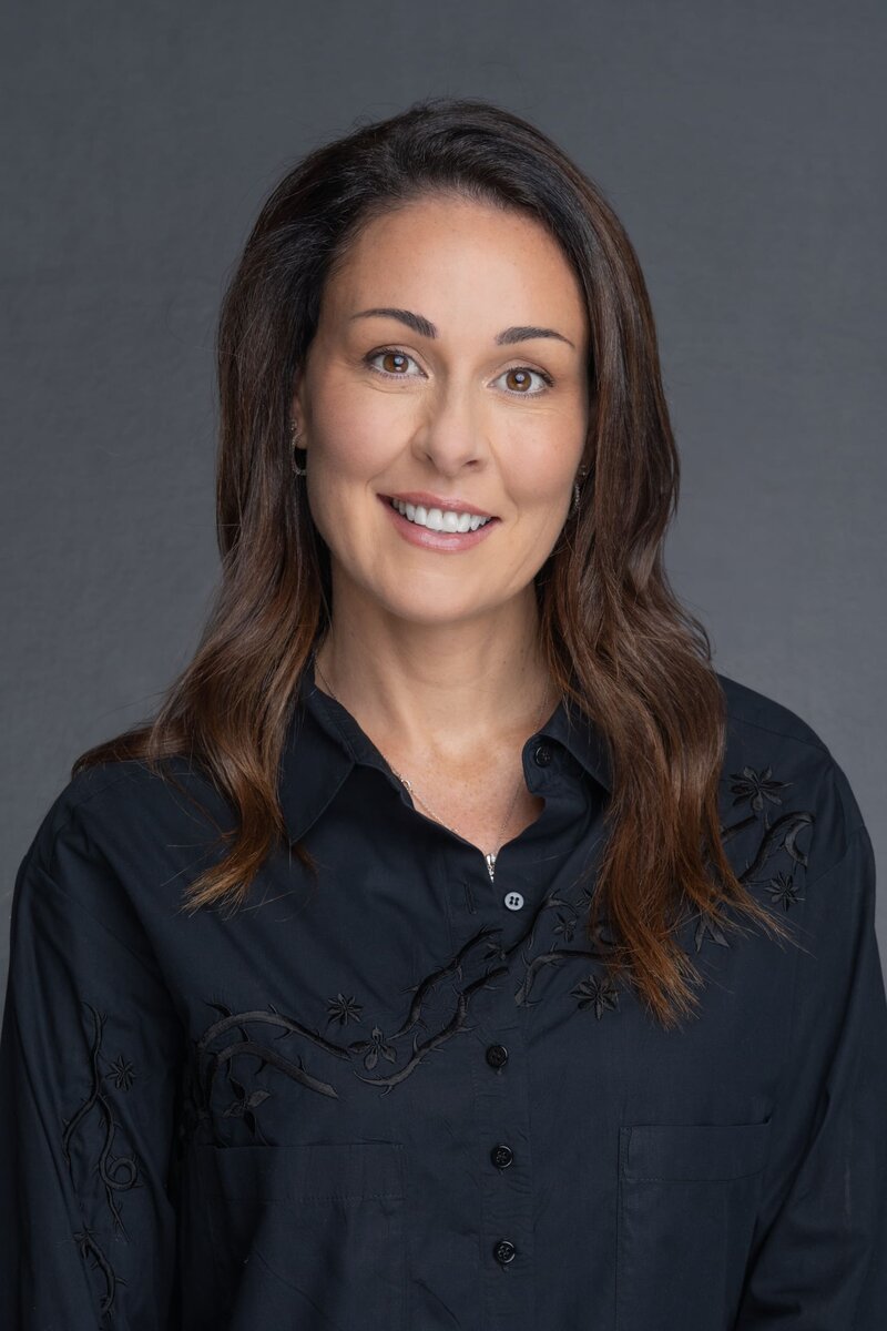 Int: Dark-haired woman man wearing a black shirt having corporate headshots taken by Sydney Photographer Georgie Greene in Sydney NSW