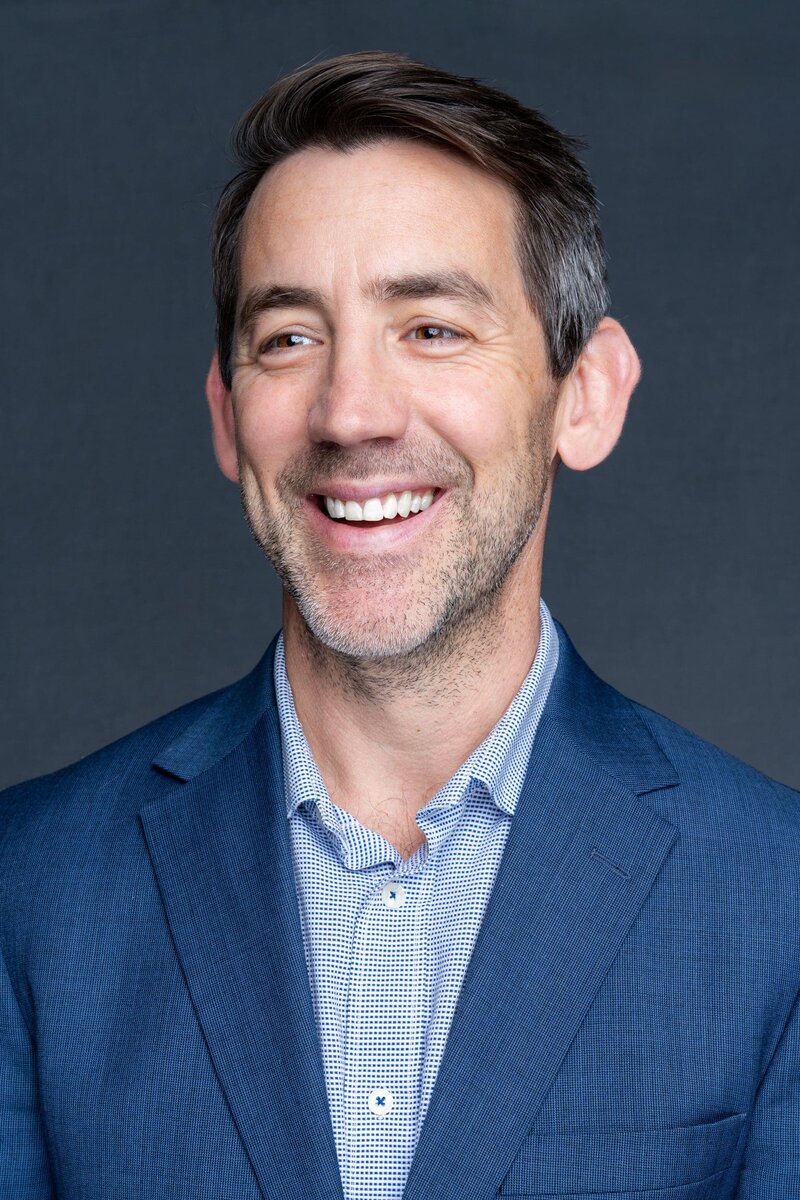 Int: young man in a blue suit having Business head shots taken by headshot photographer Georgie Greene in Sydney NSW