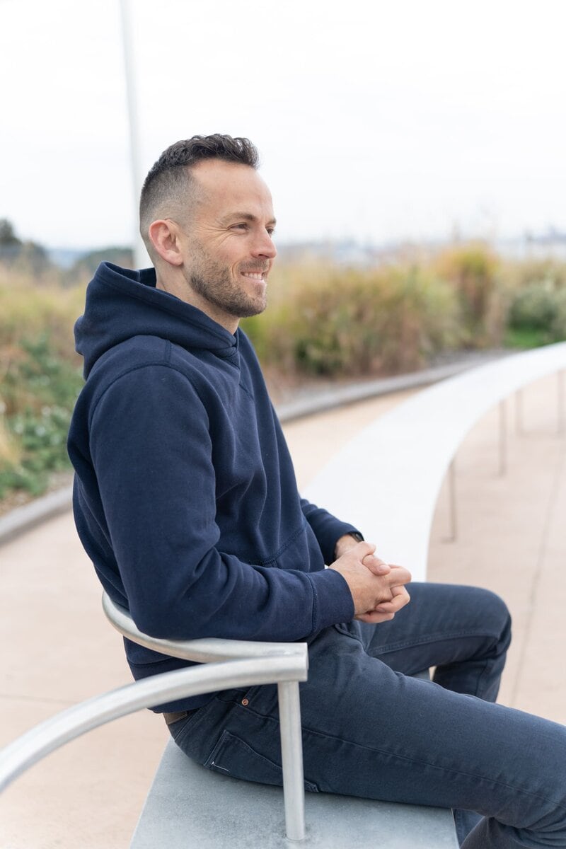 Ext: Young man wearing a blue hoodie having a photo for dating taken by dating photographer Georgie Greene in Sydney NSW