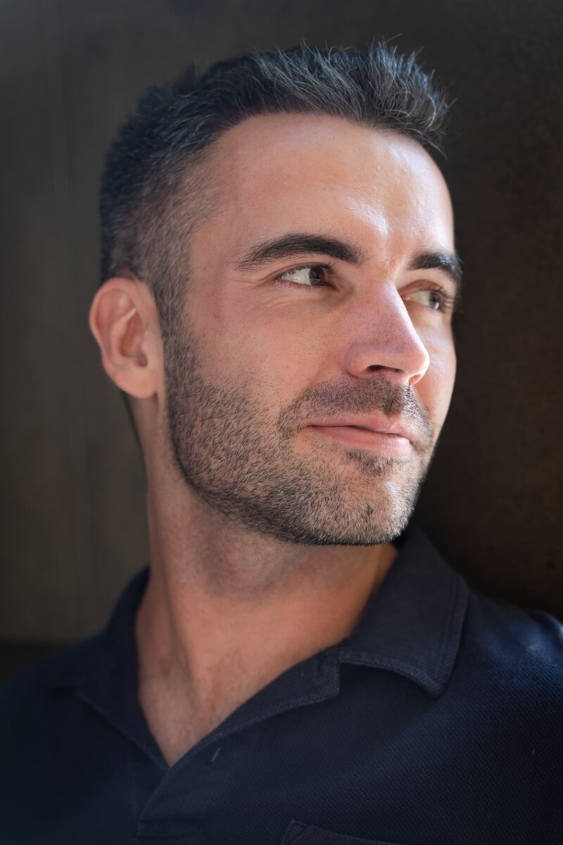 Ext: Young man in a black shirt having a dating photoshoot with dating app photographer Georgie Greene in Sydney NSW