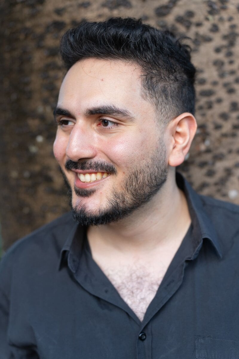 Ext: Young man wearing a black shirt having a Sydney dating photo taken with dating photographer Georgie Greene in Sydney NSW