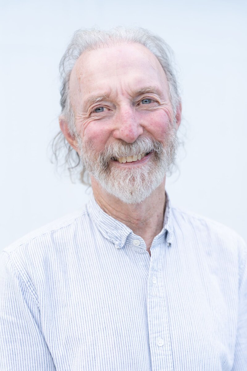 older man with white hair and a beard having his portrait taken by professional photographer Georgie Greene in Sydney NSW
