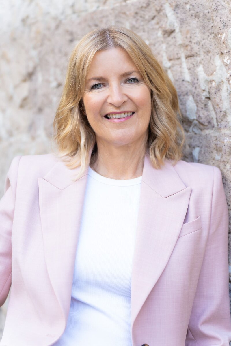 Woman in a pink suite having a LinkedIn headshot taken by professional photographer Georgie Greene in Sydney NSW