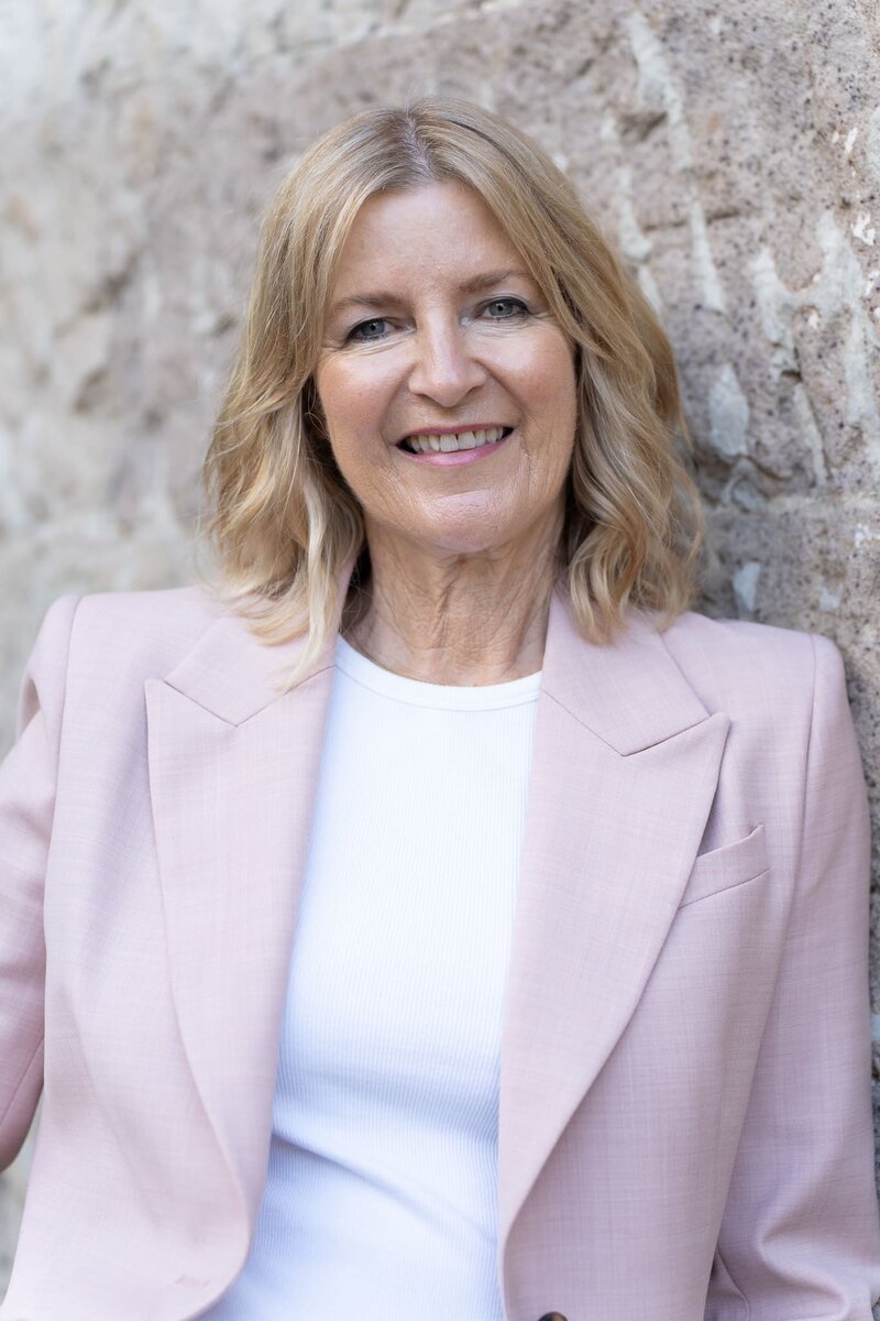 Woman in a pink suite having a LinkedIn headshot taken by headshot photographer Georgie Greene in Sydney NSW