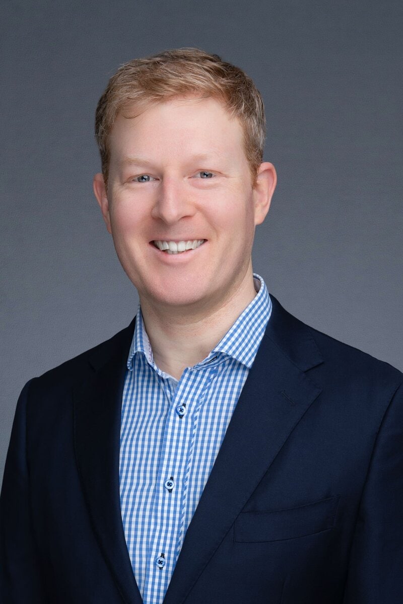 Redhead man in blue shirt having his Sydney headshots taken by Photographer Georgie Greene in Sydney NSW