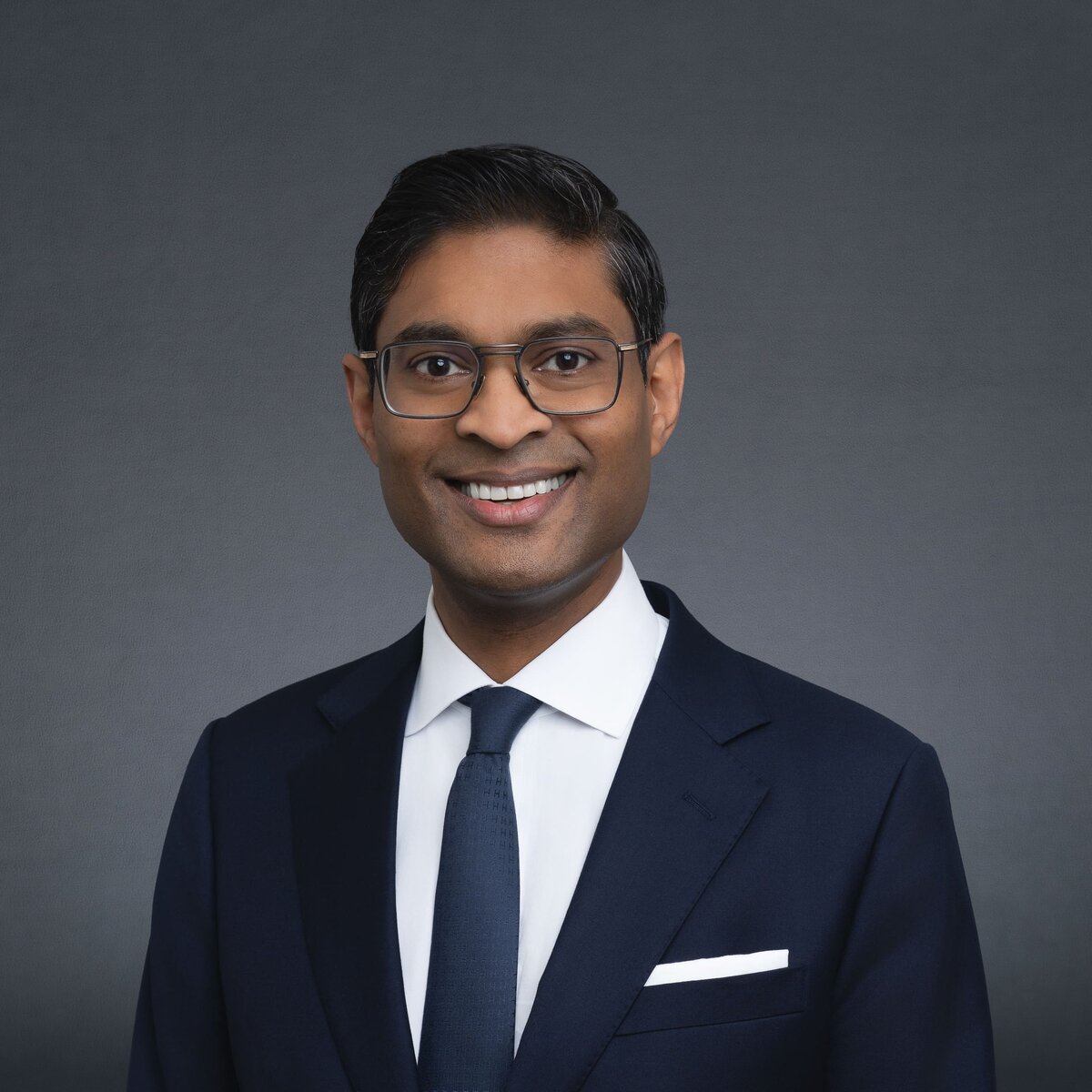 Indian Lawyer wearing black and having his professional headshot taken by Sydney Professional photographer Georgie Greene