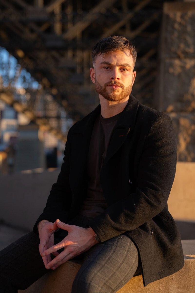 Young actor wearing a black coat having his headshot taken by Sydney headshot photographer Georgie Greene
