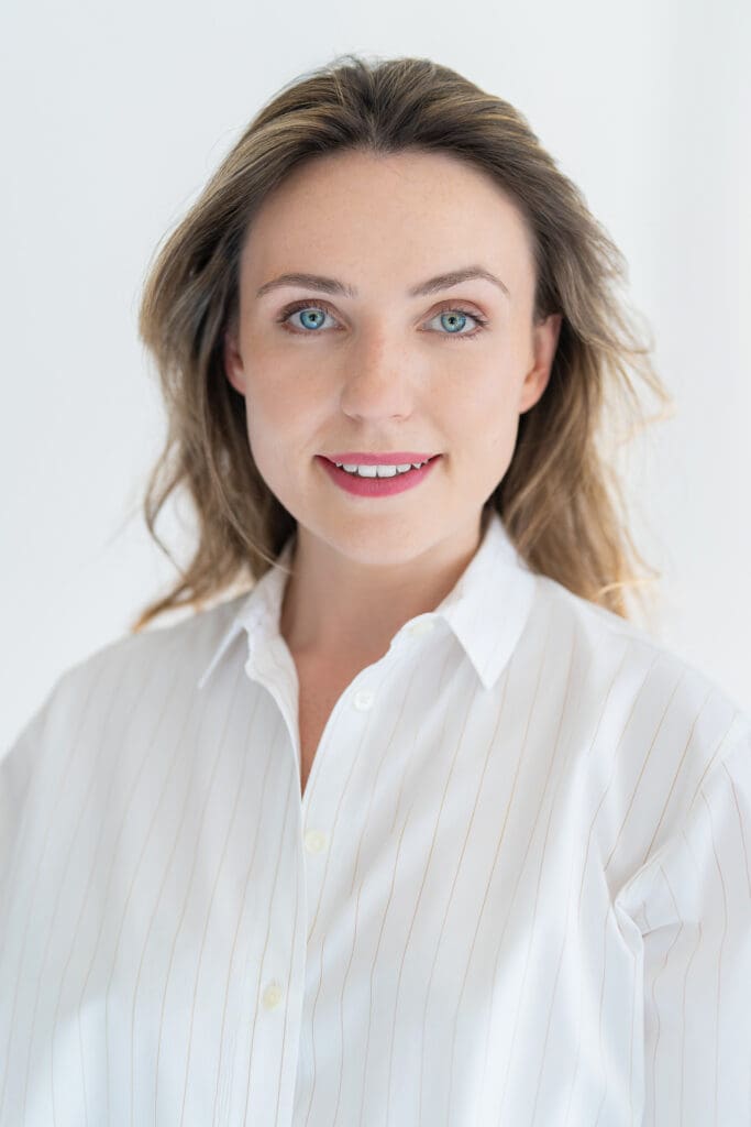 Young woman in a white top having your LinkedIn headshot taken by professional photographer Georgie Greene Sydney NSW
