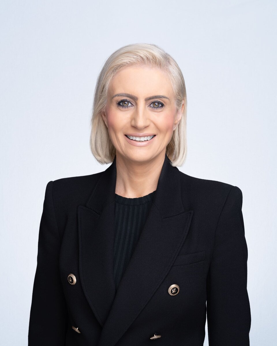 Young woman wearing a black blazer having her company headshot taken by Sydney corporate photographer Georgie Greene