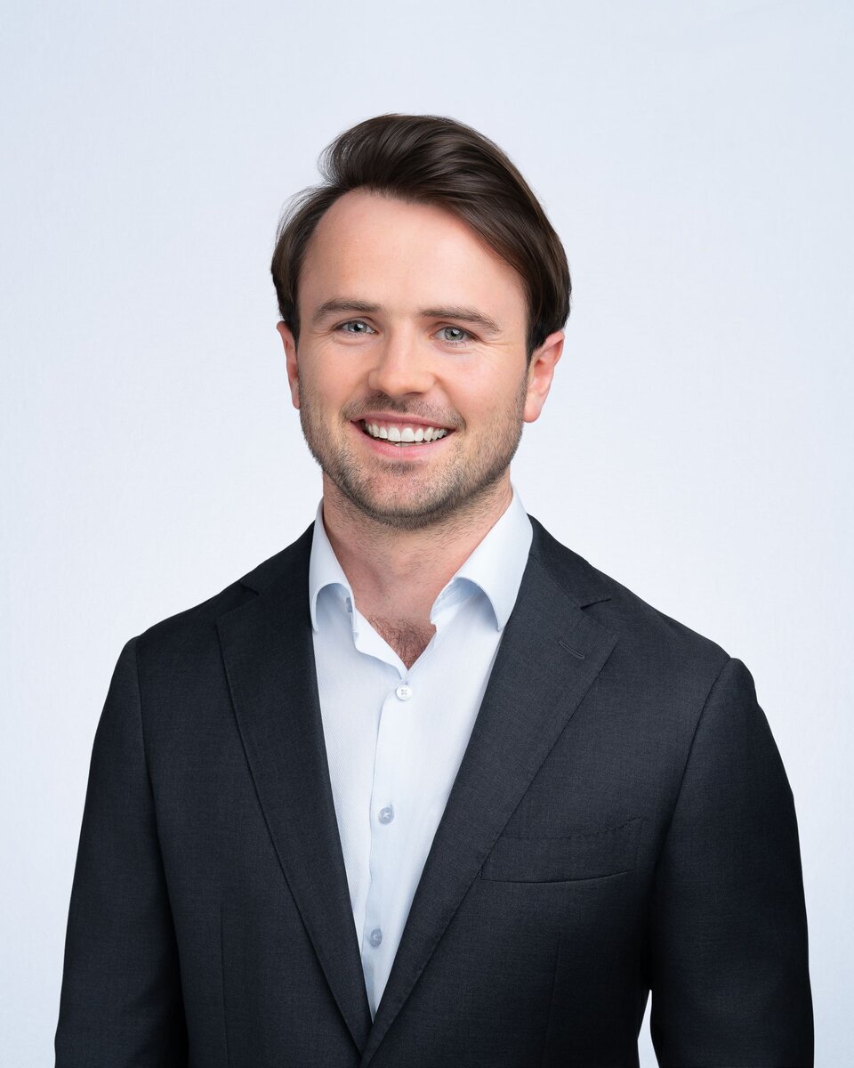 Young man wearing a blue jacket having his company headshot taken by Sydney headshot photographer Georgie Greene