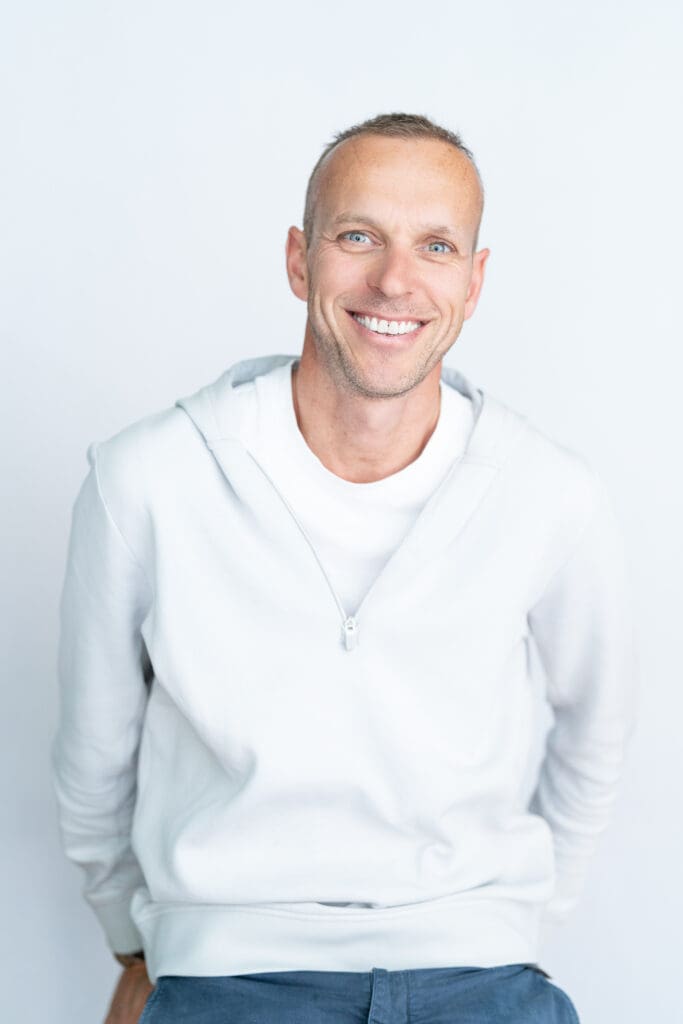 Blonde Sydney CEO wearing a white top having his headshot taken by Sydney professional photographer Georgie Greene