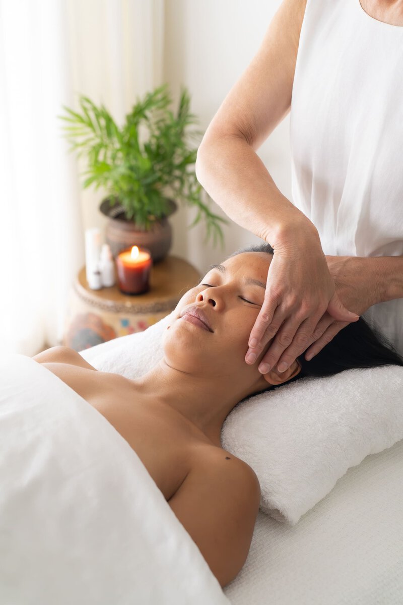 Beauty therapist massaging a client's head as she has her personal branding photo taken by Sydney professional photographer Georgie Greene