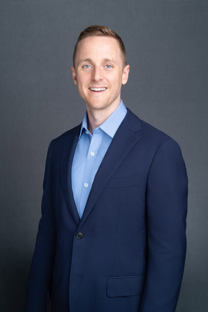 Sydney headshot of a young man wearing a blue suit and shirt