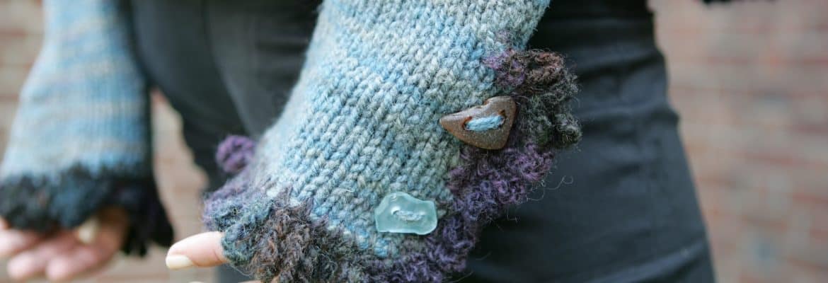 Hand-knit sweater with colorful yarn details, featuring buttons and textured trims. Perfect for cozy winter wear, highlighting artisanal wool yarns from SeaColors Yarnery.