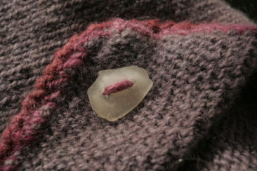 Soft, multi-colored wool yarn with pink and purple tones, featuring a sea-inspired aesthetic, perfect for knitting or crochet projects from Seacolors Yarnery.