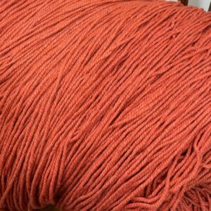 Vibrant burnt orange color chunky yarn for knitting and crochet projects, perfect for cozy accessories and home decor. Soft, thick, and suitable for various creative fiber arts.