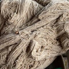 Soft beige natural wool yarn for knitting and crochet, eco-friendly fiber, artisanal craft supplies, textured and sustainable yarn for handmade projects and fiber arts.