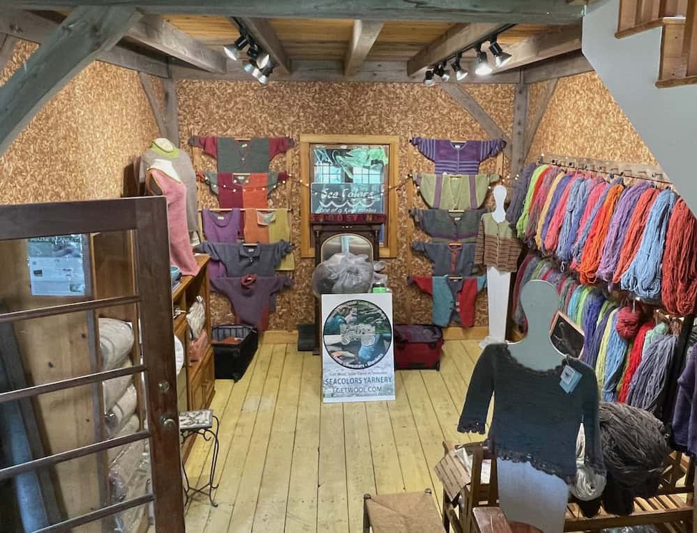Colorful yarn and knitting supplies display at SeaColors Yarnery, emphasizing vibrant yarns, hand-dyed fibers, and cozy crafting materials from GetWool for knitting and crochet enthusiasts.