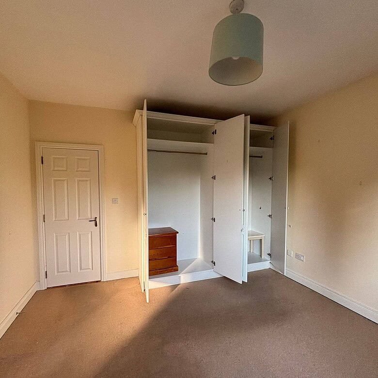 Mullingar bright bedroom interior with a built-in wardrobe and a closed white door. – Ghar.ie property listing