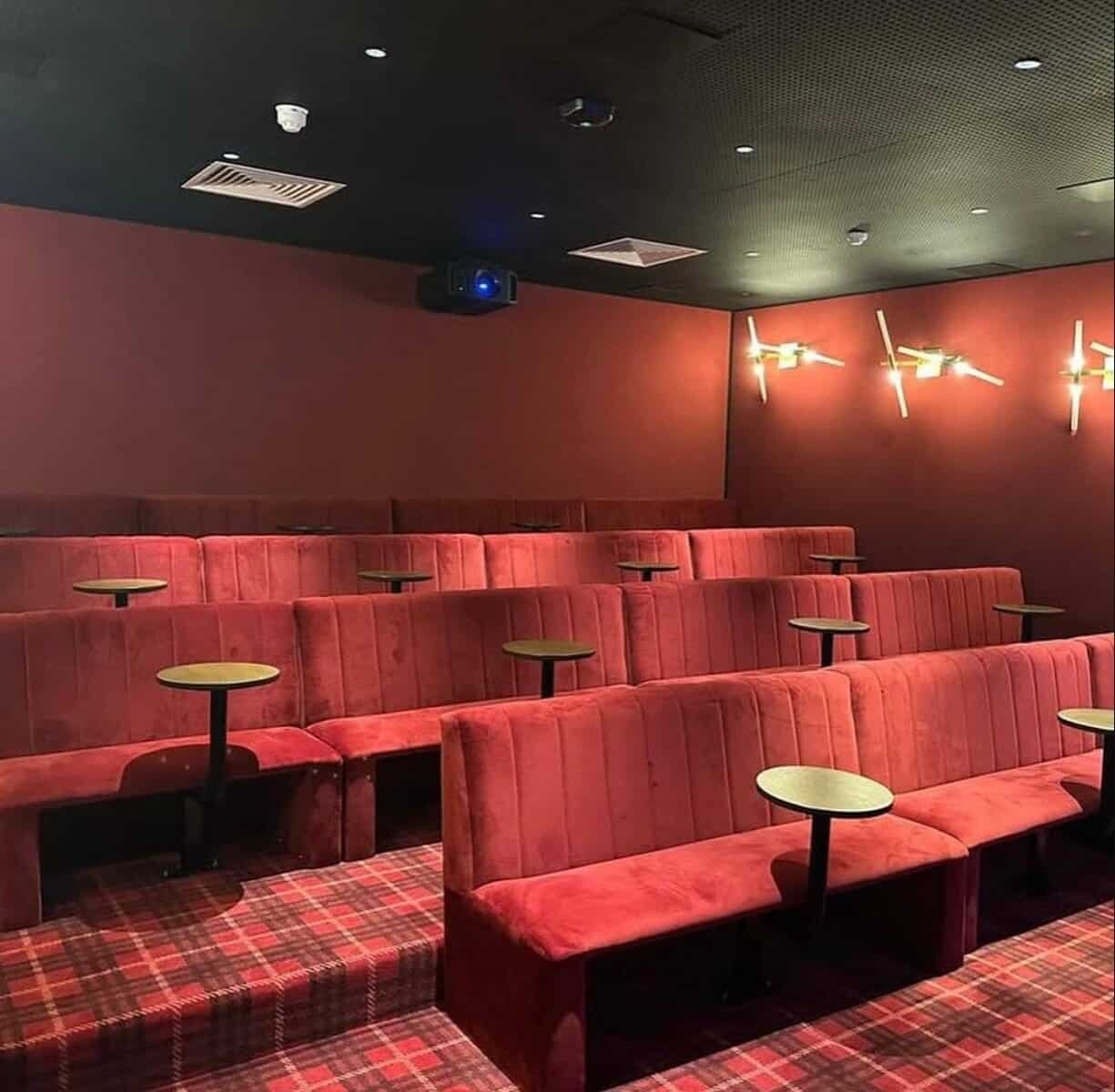 Small private cinema room with red seating and tartan carpet, perfect for a cozy movie night. – Ghar.ie property listing