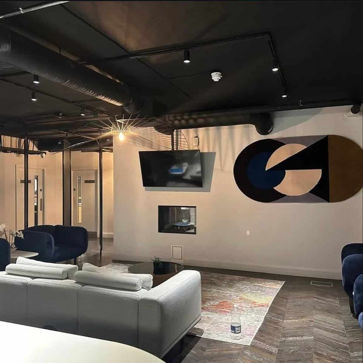 Comfortable Dublin room for rent, featuring a modern interior with sofas, lighting, and herringbone flooring. – Ghar.ie property listing