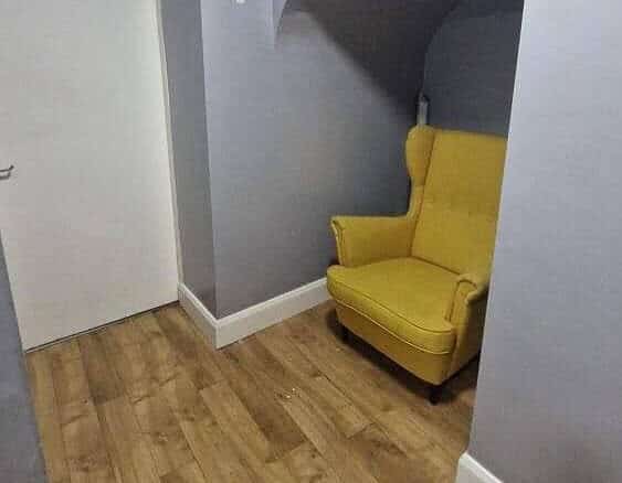 Bright yellow armchair nestled in an alcove in a modern apartment in Fairview, Dublin. – Ghar.ie property listing