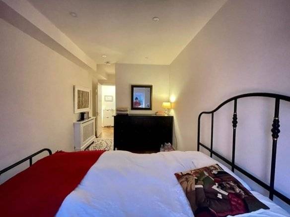 Bedroom in the Ringsend apartment for rent, featuring a black metal bed frame and dresser. – Ghar.ie property listing