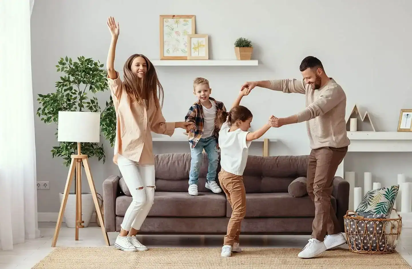 Happy family dancing in their living room. A great example of homes for sale Ireland. – Ghar.ie property listing