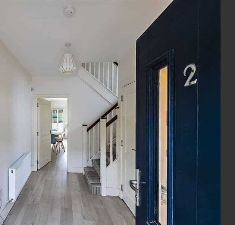 Hallway view in a home with stairs, a living room, and a dining area. – Ghar.ie property listing