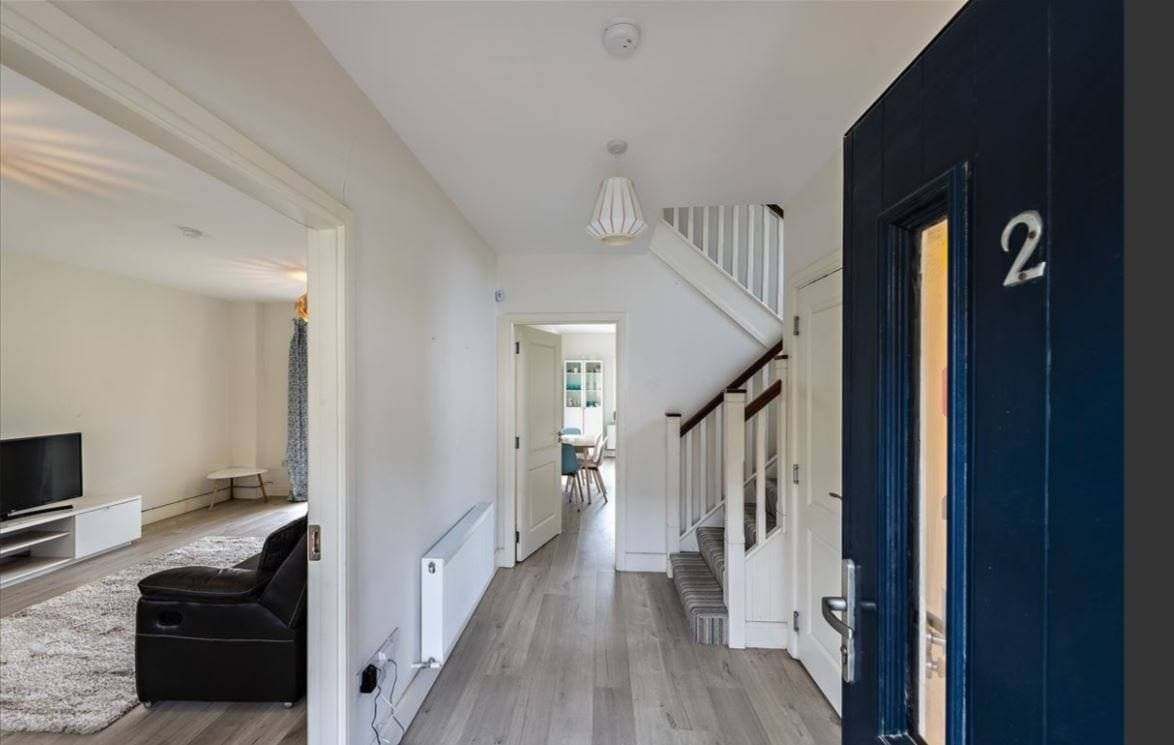 Hallway view in a home with stairs, a living room, and a dining area. – Ghar.ie property listing