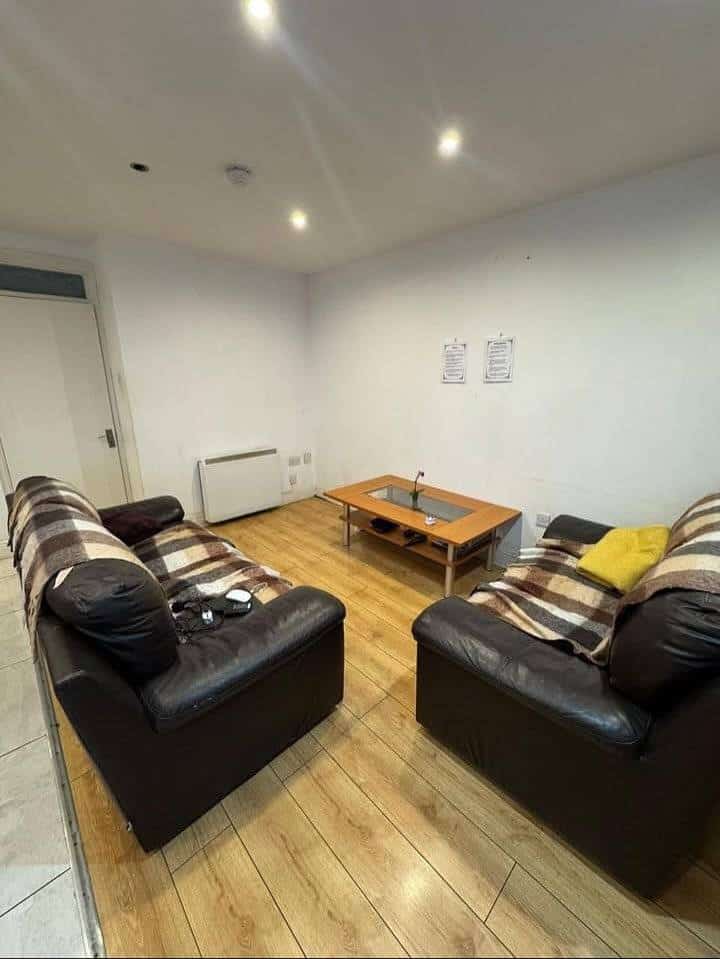 Living room in Dublin 1 rental with two leather sofas, a coffee table, and wood flooring. – Ghar.ie property listing