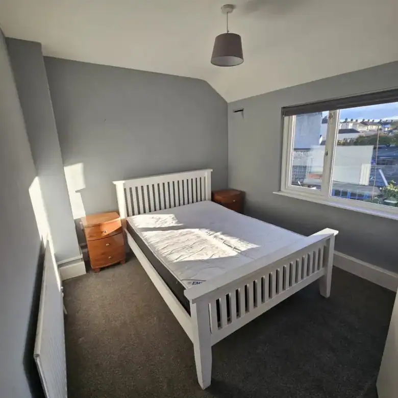 Bedroom in a 2-bedroom apartment for rent in Drimnagh, Dublin 12, with white bed frame. – Ghar.ie property listing