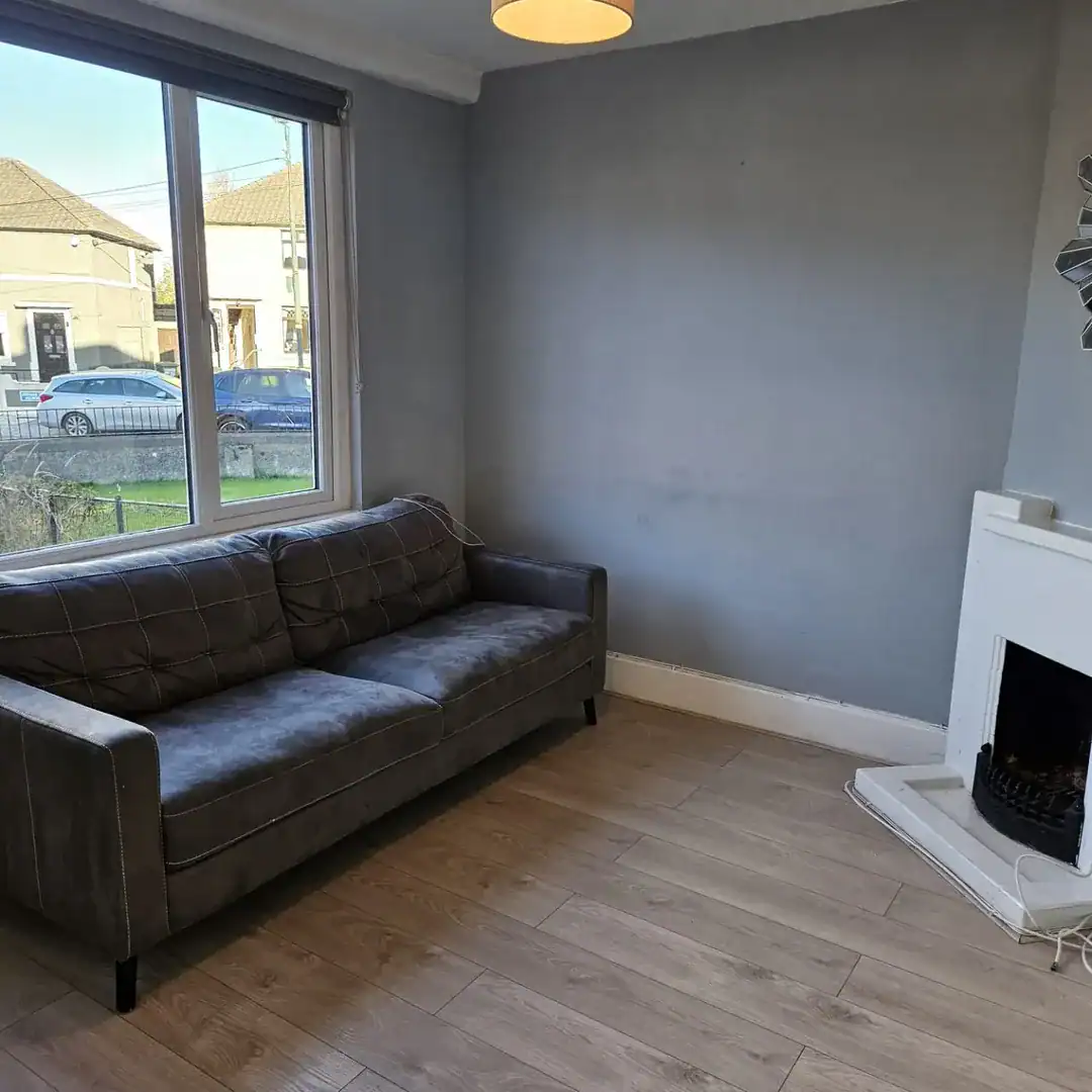 Living room in the Drimnagh, Dublin 12 apartment with a grey sofa and fireplace. – Ghar.ie property listing