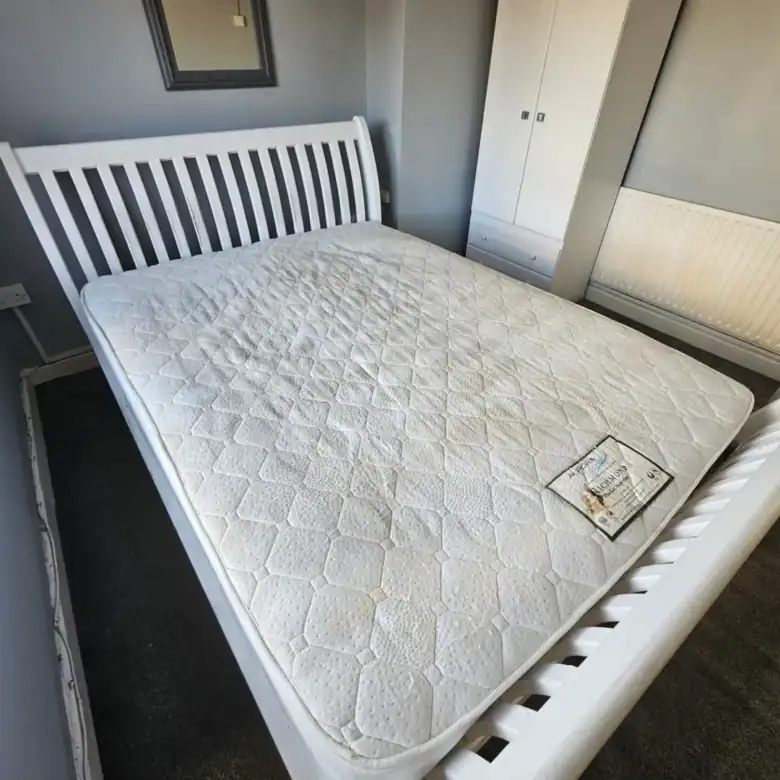 Bedroom in a Drimnagh apartment for rent, featuring a white bed frame and mattress. – Ghar.ie property listing