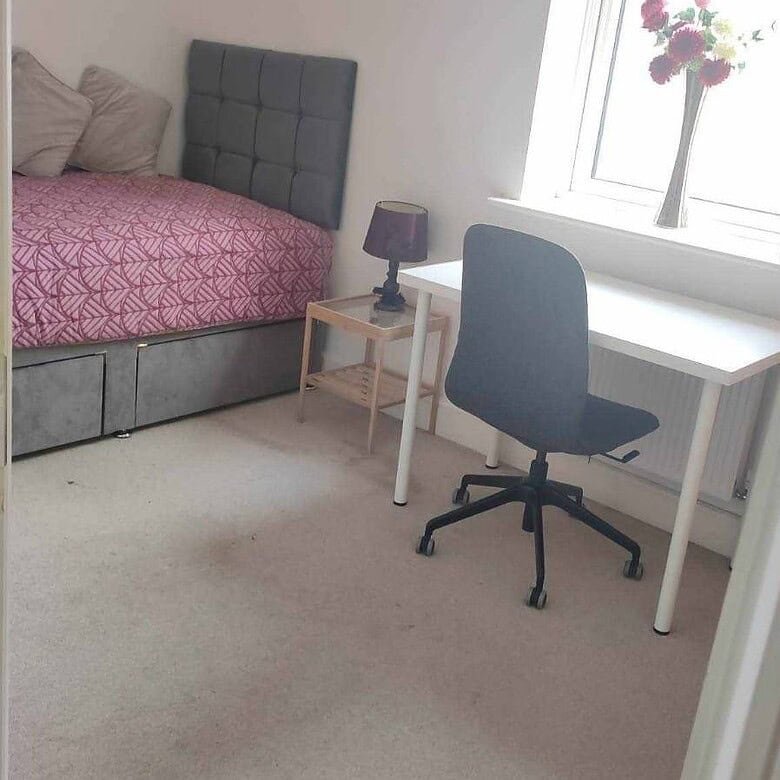 Single occupancy bedroom with a bed, desk, chair, and window providing natural light. – Ghar.ie property listing