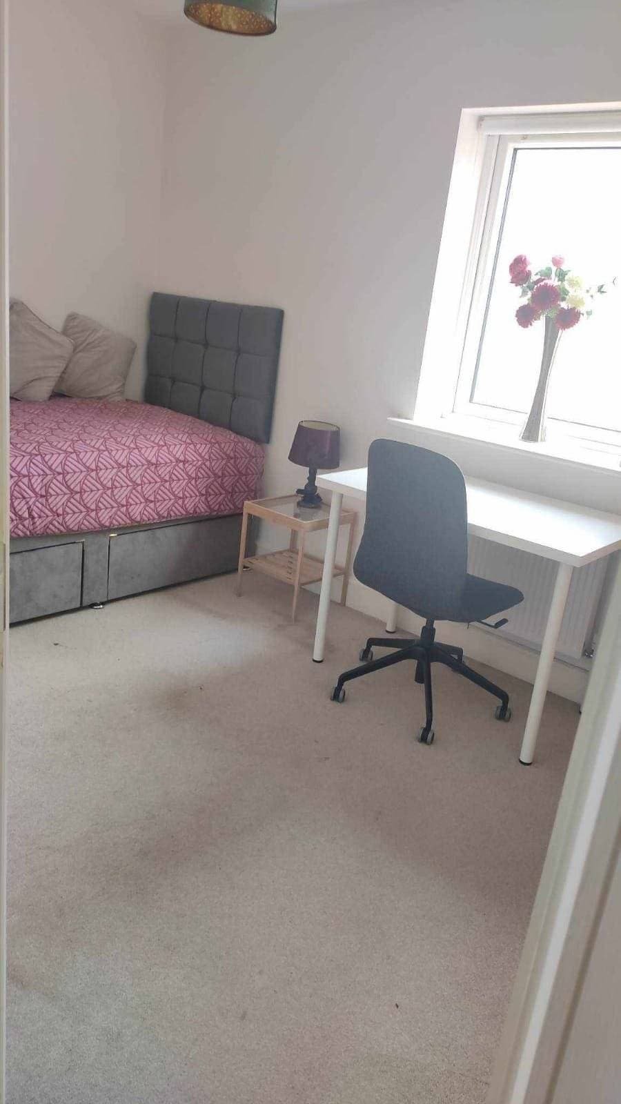 Single occupancy bedroom with a bed, desk, chair, and window providing natural light. – Ghar.ie property listing