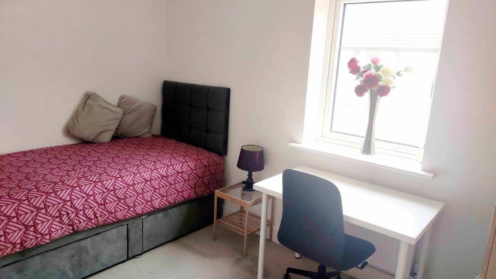 Single bedroom with bed, desk, chair, and window, available for private occupancy. – Ghar.ie property listing