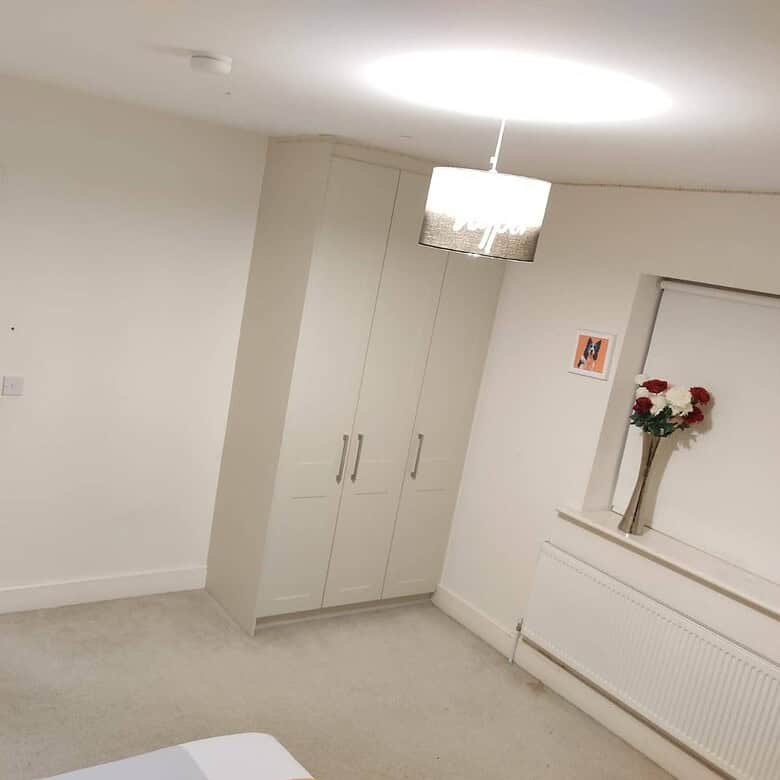 Private single occupancy bedroom with a wardrobe, door, radiator, flowers, and overhead lighting. – Ghar.ie property listing