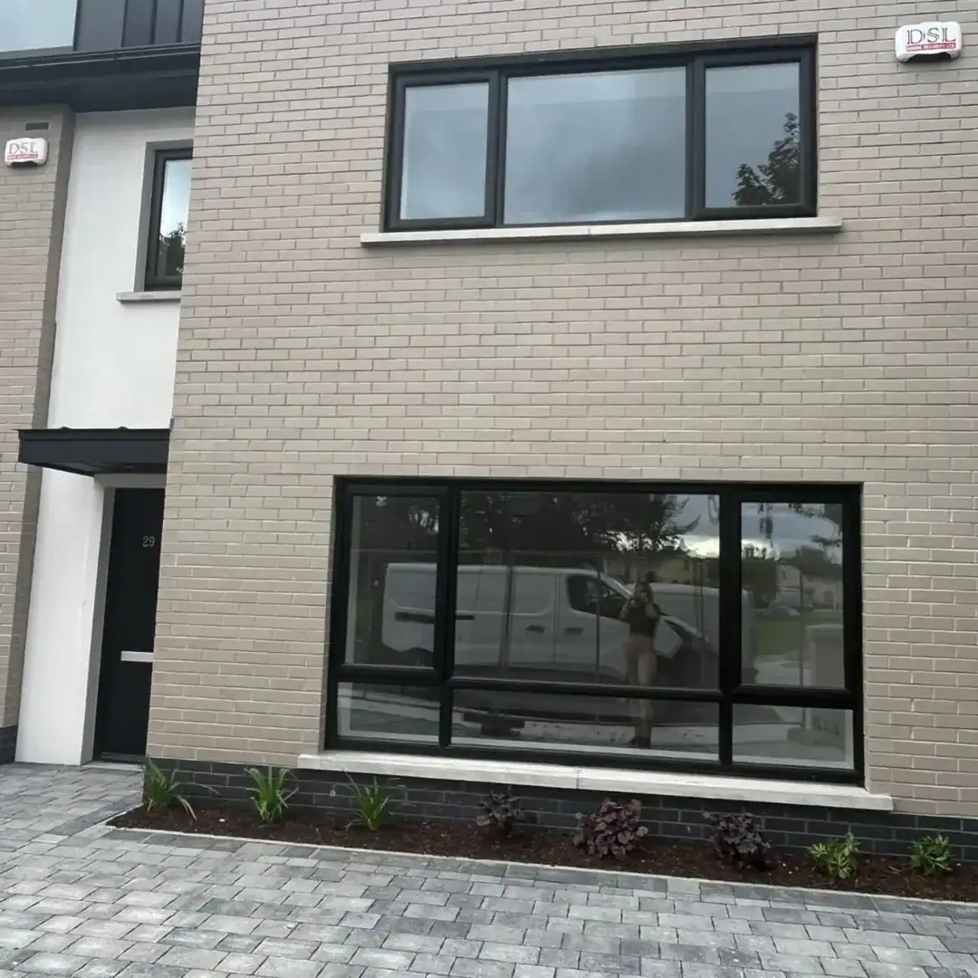 Exterior of a modern house in Blanchardstown D15 with large windows and a paved driveway. – Ghar.ie property listing