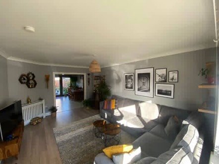Cozy living room with large sectional sofa and natural light.