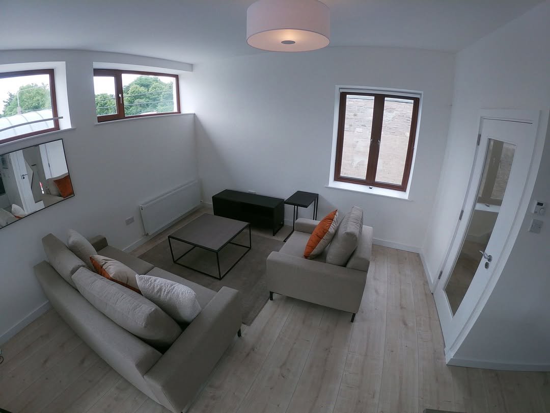 Bright living room with beige sofa, gray coffee table, and natural light.