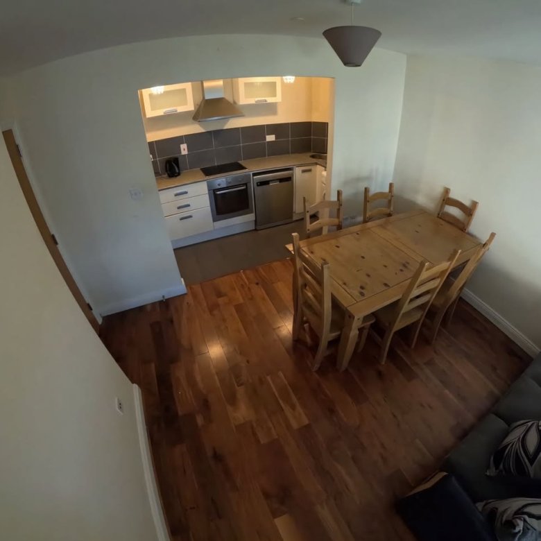 Cozy kitchen and dining area with wood table and seating.