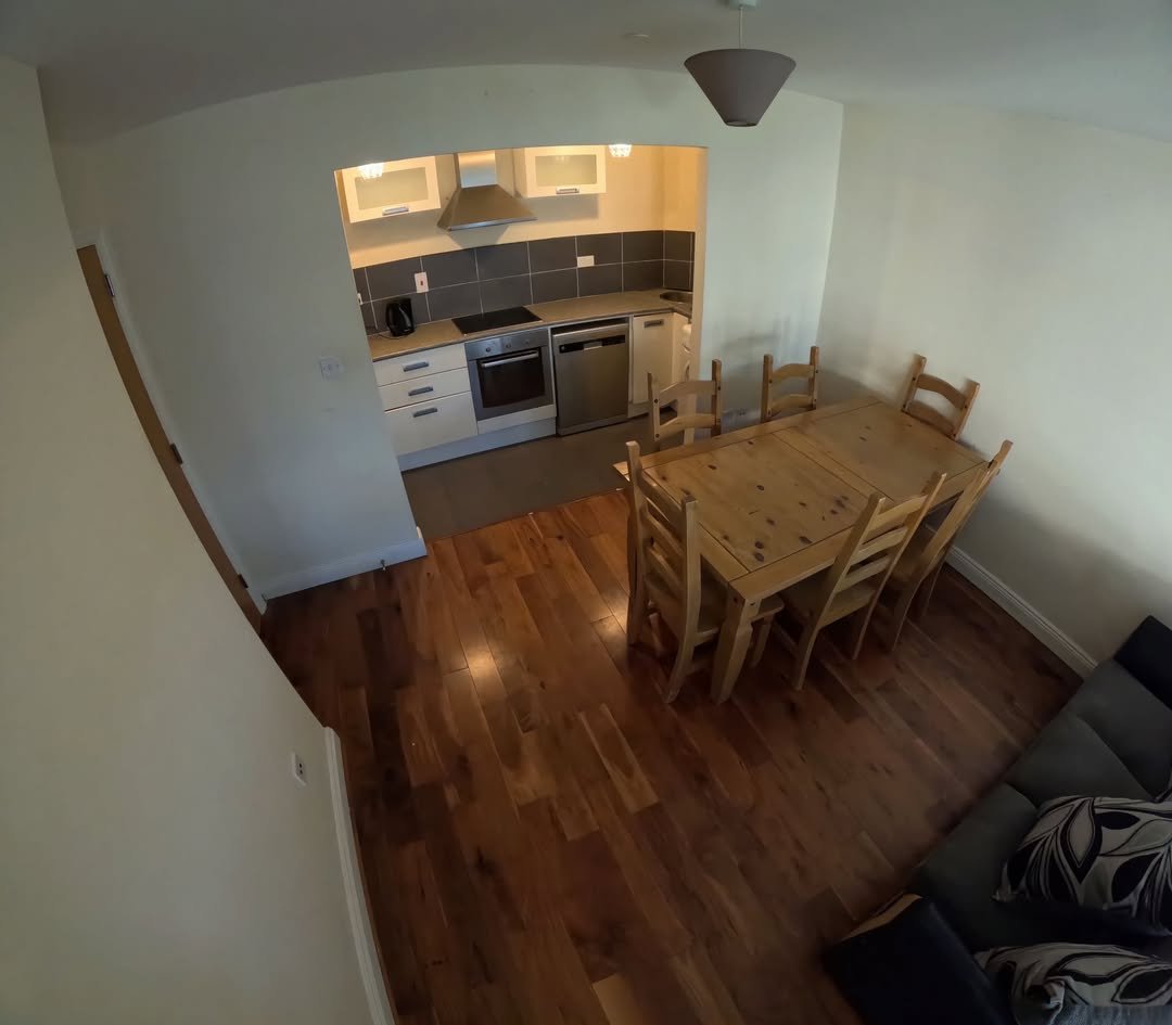 Cozy kitchen and dining area with wood table and seating.