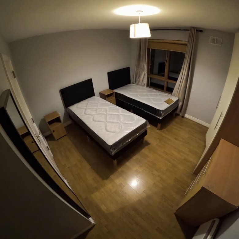 Bedroom with two single beds, bedside tables, and wardrobe. Interior design.