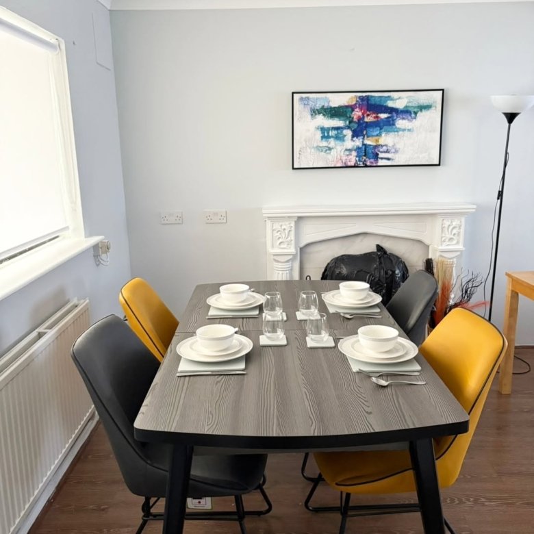 Dining table set with plates and glasses in a modern dining room.