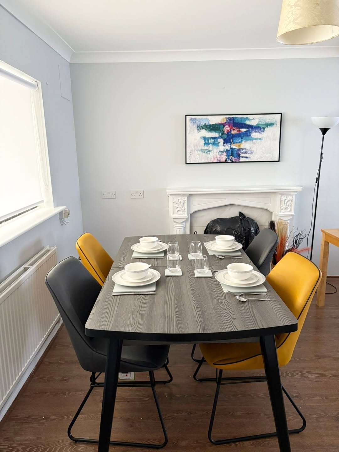 Dining table set with plates and glasses in a modern dining room.