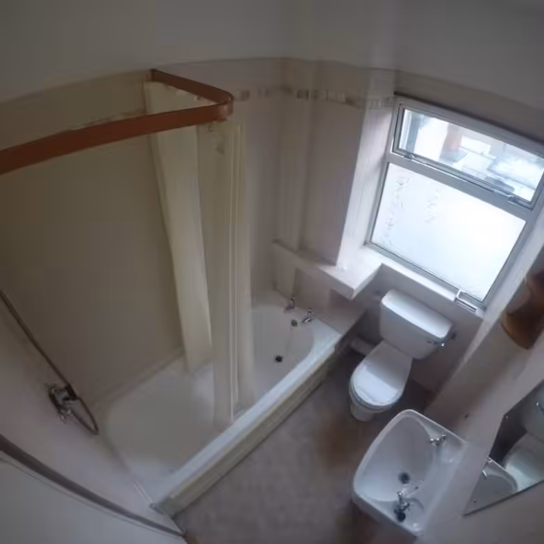 Compact bathroom with shower, tub, toilet, sink, and window. Neutral color scheme.